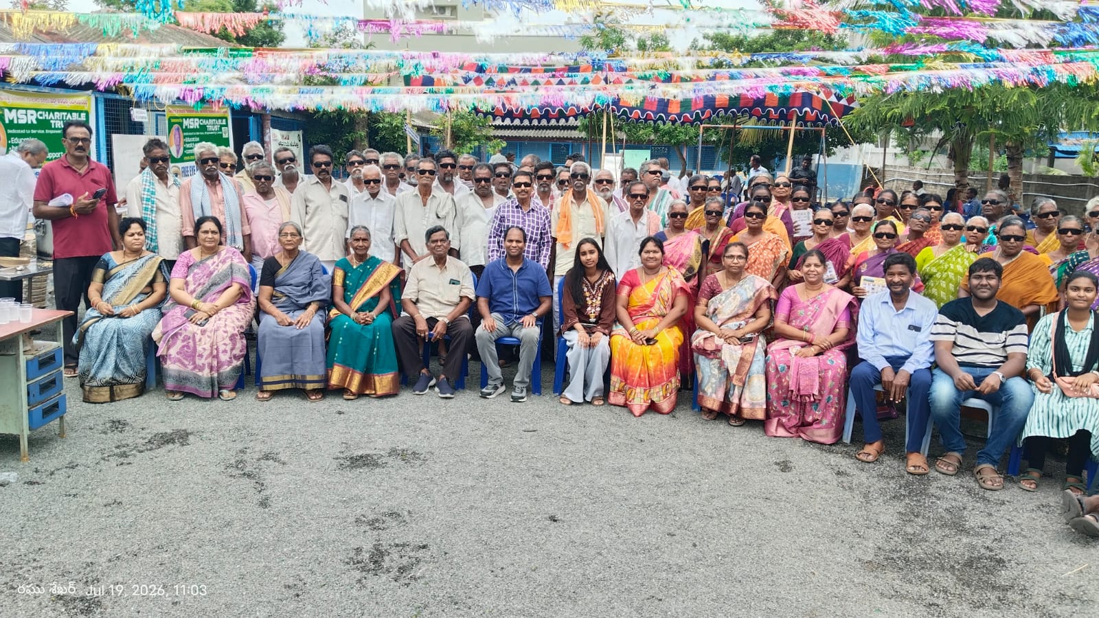 Elderly patients wearing post-operative sunglasses at a free eye camp