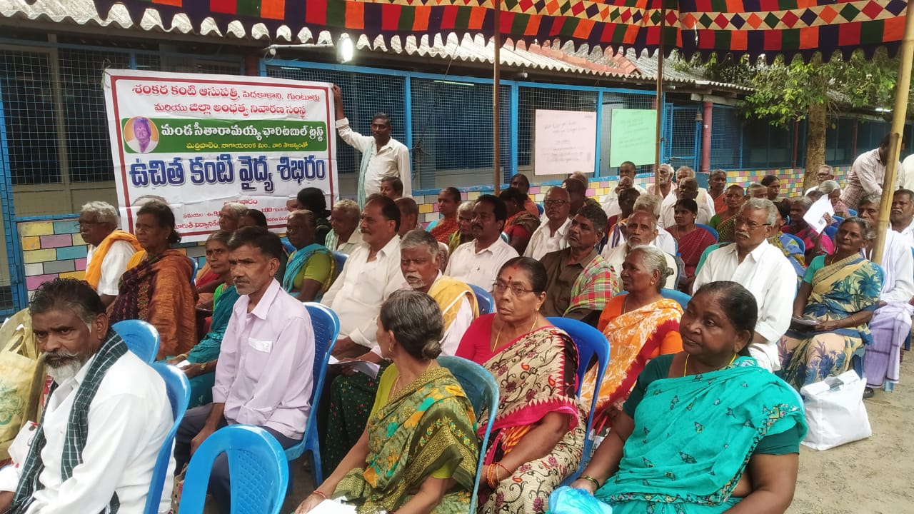 Community members seated and waiting to be screened at a free eye camp