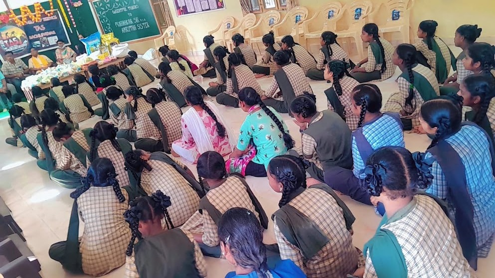 School children assembled during a community support and food distribution program