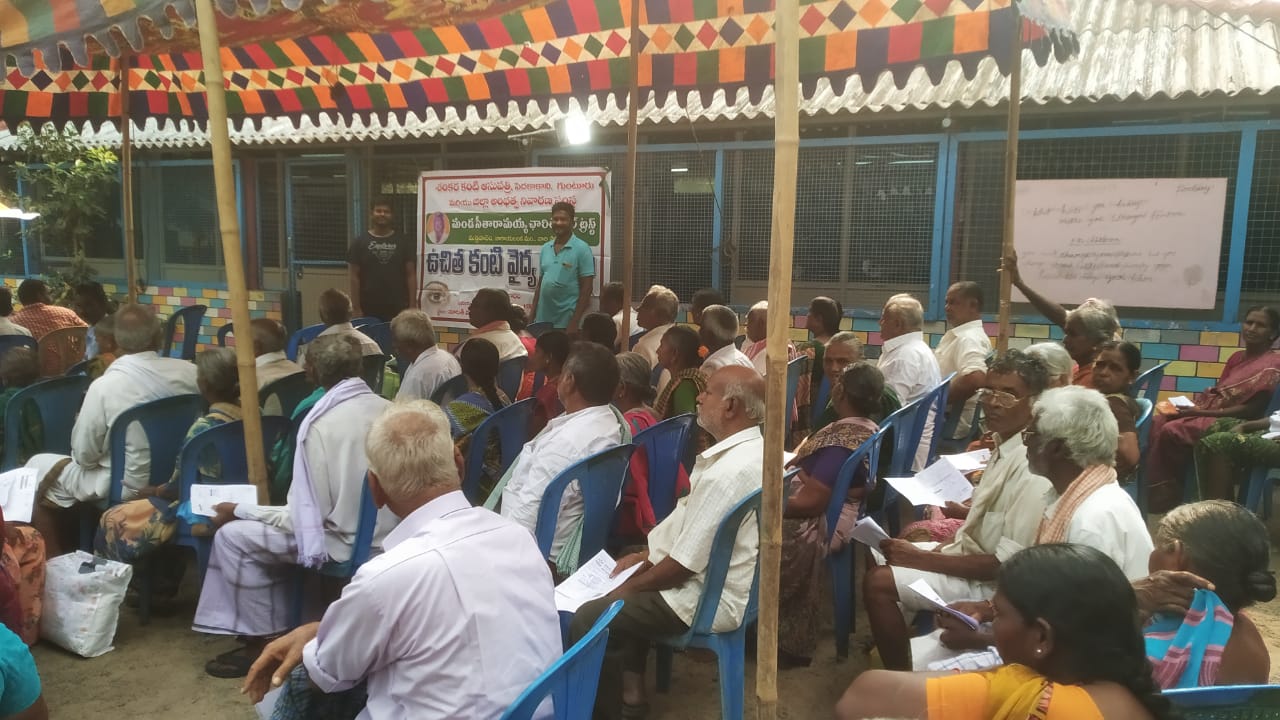 Attendees holding screening forms during a free eye camp registration